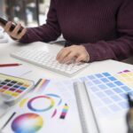 young-female-designer-checking-her-smartphone